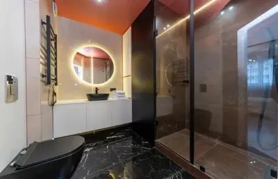 a bathroom with a glass shower and a toilet at Apartmani Drivasko in Sveti Stefan