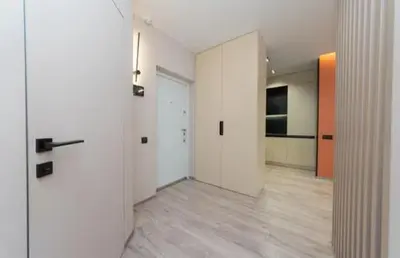 a room with a hallway with white walls and wood floors at Apartmani Drivasko in Sveti Stefan