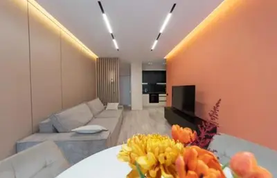a living room with a couch and a table with flowers at Apartmani Drivasko in Sveti Stefan