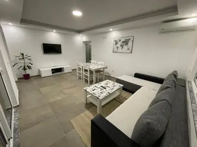 a living room with a couch and a table at Apart Sara in Ulcinj