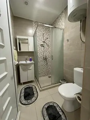 a small bathroom with a toilet and a shower at Apart Sara in Ulcinj