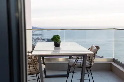 a table with a potted plant sitting on top of a balcony at Seaview Residence in Dobra Voda