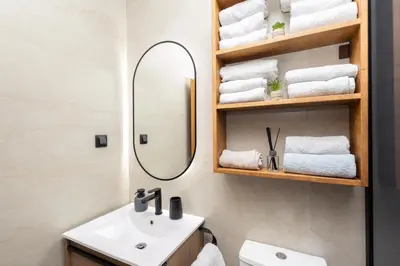 a bathroom with a sink and a mirror and towels at Seaview Residence in Dobra Voda