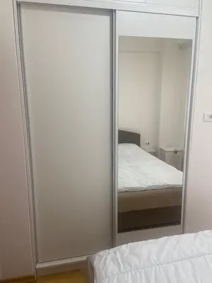 a mirrored closet in a bedroom with a bed at Modern 1BR Apartment in Ljubović Podgorica in Podgorica