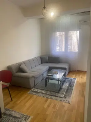 a living room with a couch and a table at Modern 1BR Apartment in Ljubović Podgorica in Podgorica
