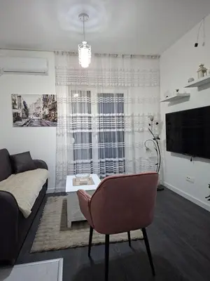 a living room with a couch and a table at Apartman Asia in Podgorica