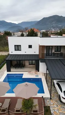 a house with a swimming pool and an umbrella at Luxury Villa Bar in Bar