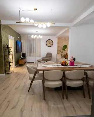 a dining room and living room with a table and chairs at Luxury Villa Bar in Bar