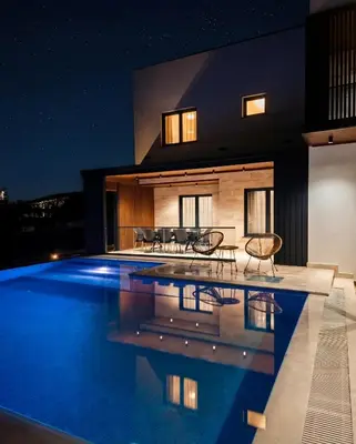a villa with a swimming pool at night at Luxury Villa Bar in Bar