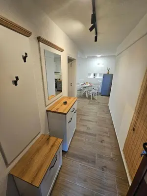 a kitchen with a counter and a table in a room at Apartment Under the Palm Tree in Budva