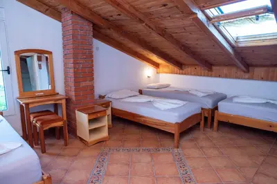 a room with three beds and a mirror at Beach House Noki 1 in Ulcinj