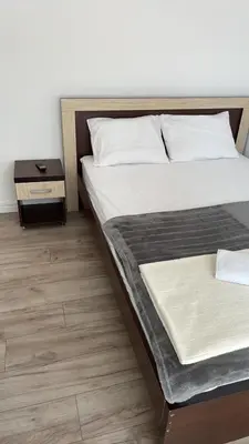 a bedroom with a bed and a nightstand next to it at Lupo in Budva