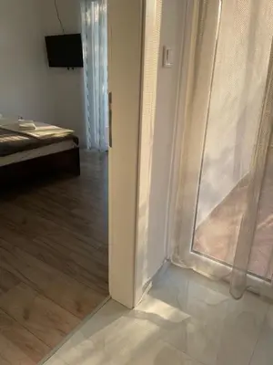 a room with a sliding glass door and a bedroom at Apartment Lupo in Budva