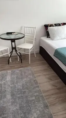 a bedroom with a bed and a table and a chair at Apartment Lupo in Budva