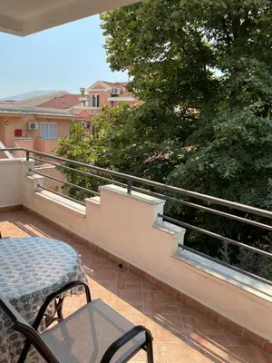 a patio with a table and chairs on a balcony at Apartment Lupo in Budva