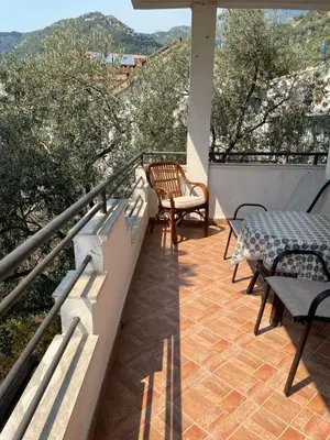 a balcony with a table and chairs on a balcony at Apartment Lupo in Budva