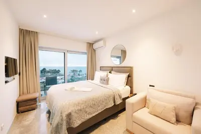 a hotel room with a bed and a couch at Hotel Senator Lux in Ulcinj