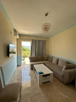 a living room with a couch and a table at Ulcinj Bay Apartmant in Ulcinj