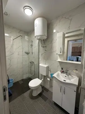 a bathroom with a toilet and a sink and a shower at Ulcinj Bay Apartmant in Ulcinj