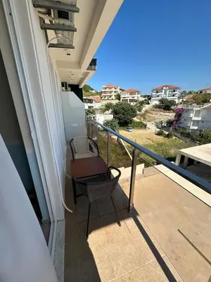 a balcony with a chair and a view of the ocean at Ulcinj Bay Apartmant in Ulcinj