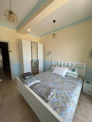 a bedroom with a bed and a mirror in it at Ulcinj Bay Apartmant in Ulcinj