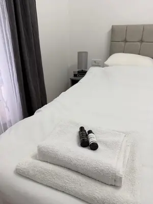 a pair of shoes sitting on a bed at Premium Suites with GARAGE in Podgorica