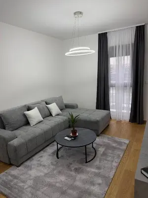 a living room with a couch and a table at Premium Suites with GARAGE in Podgorica