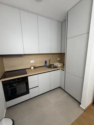 a kitchen with white cabinets and a sink at Premium Suites with GARAGE in Podgorica