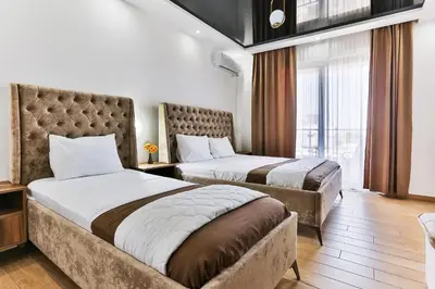 a hotel room with two beds and a window at Hotel Hoti 2 Wellnes & Spa in Ulcinj