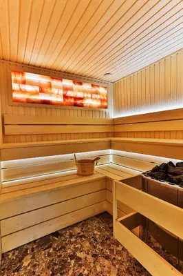 a wooden sauna with a basket in it at Hotel Hoti 2 Wellnes & Spa in Ulcinj
