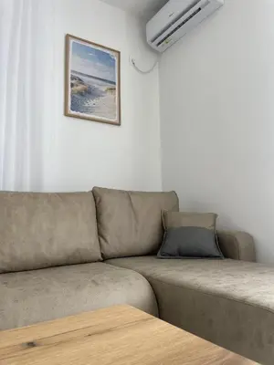 a couch in a living room with a picture on the wall at Hotel Hoti 2 Wellnes & Spa in Ulcinj