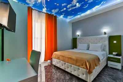 a bedroom with a bed with a blue ceiling at Hotel Hoti 2 Wellnes & Spa in Ulcinj