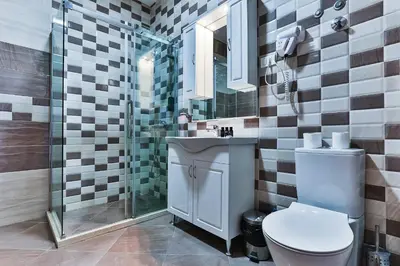a bathroom with a toilet and a sink and a shower at Hotel Hoti 2 Wellnes & Spa in Ulcinj