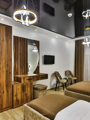 a hotel room with two beds and a tv at Hotel Hoti 2 Wellnes & Spa in Ulcinj