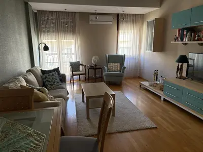 a living room with a couch and a table at Cozy apartment in the very city center in Podgorica