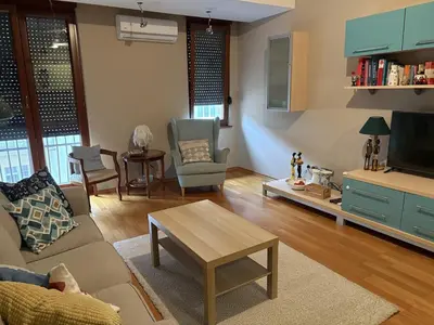 a living room with a couch and a table at Cozy apartment in the very city center in Podgorica