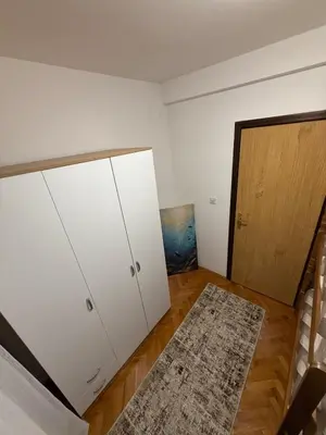 a room with white cabinets and a door and a rug at Sunčana oaza, Sutomore in Sutomore