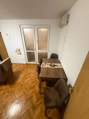 a dining room with a wooden table and chairs at Sunčana oaza, Sutomore in Sutomore