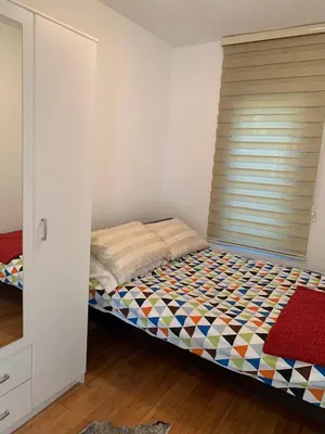 a bedroom with a bed with a window in it at Villa Andrea Lower Level in Kavač