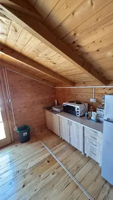 an empty room with a kitchen in a wooden house at Ada Bojana River House 1 in Ulcinj