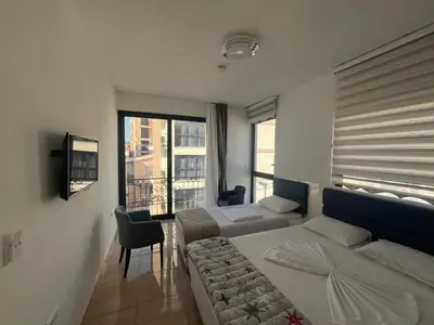 a hotel room with two beds and a window at Montebay Studio in Dobra Voda