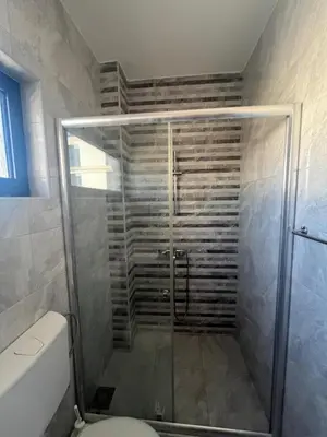 a shower with a glass door in a bathroom at Montebay Studio in Dobra Voda