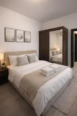 a bedroom with a large bed with a large mirror at Modern Apartment Near the Beach - Budva in Budva