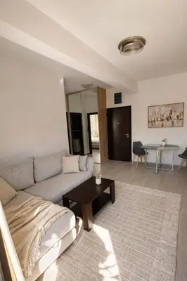 a living room with a couch and a table at Modern Apartment Near the Beach - Budva in Budva