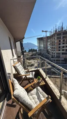 a balcony with chairs and a view of a city at Modern Apartment Near the Beach - Budva in Budva