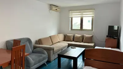 a living room with a couch and a table at Apart Ludmila in Becici