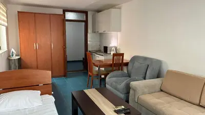 a small living room with a couch and a table at Apart Ludmila in Becici