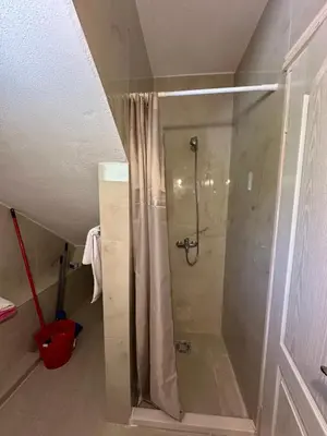 a shower with a glass door in a bathroom at Studio KIKA in Tivat