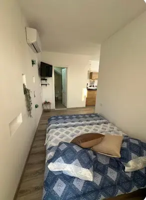 a bedroom with a bed in a small room at Studio KIKA in Tivat