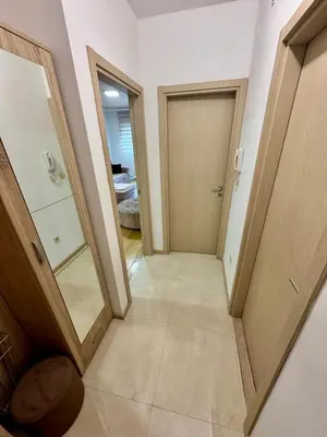 a hallway with two doors and a tile floor at Modern City Apartment in Podgorica